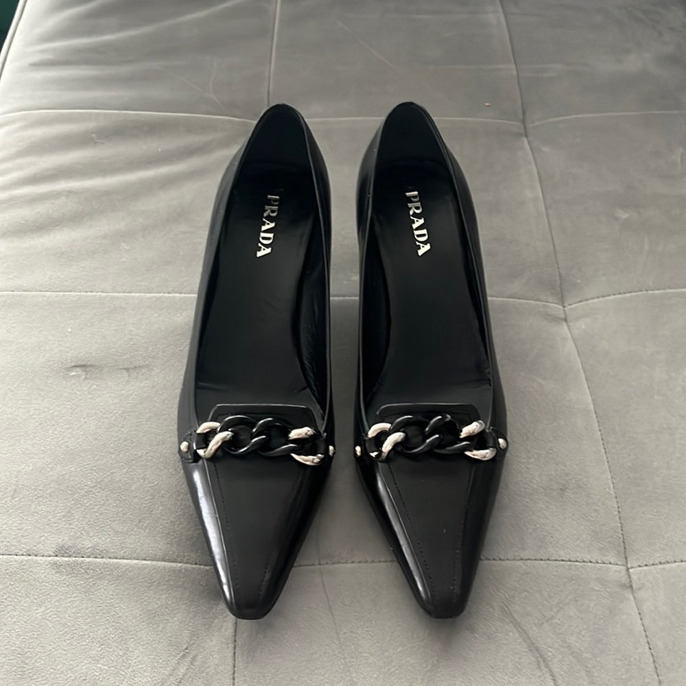 Prada pointed kitten heels with buckle detail.